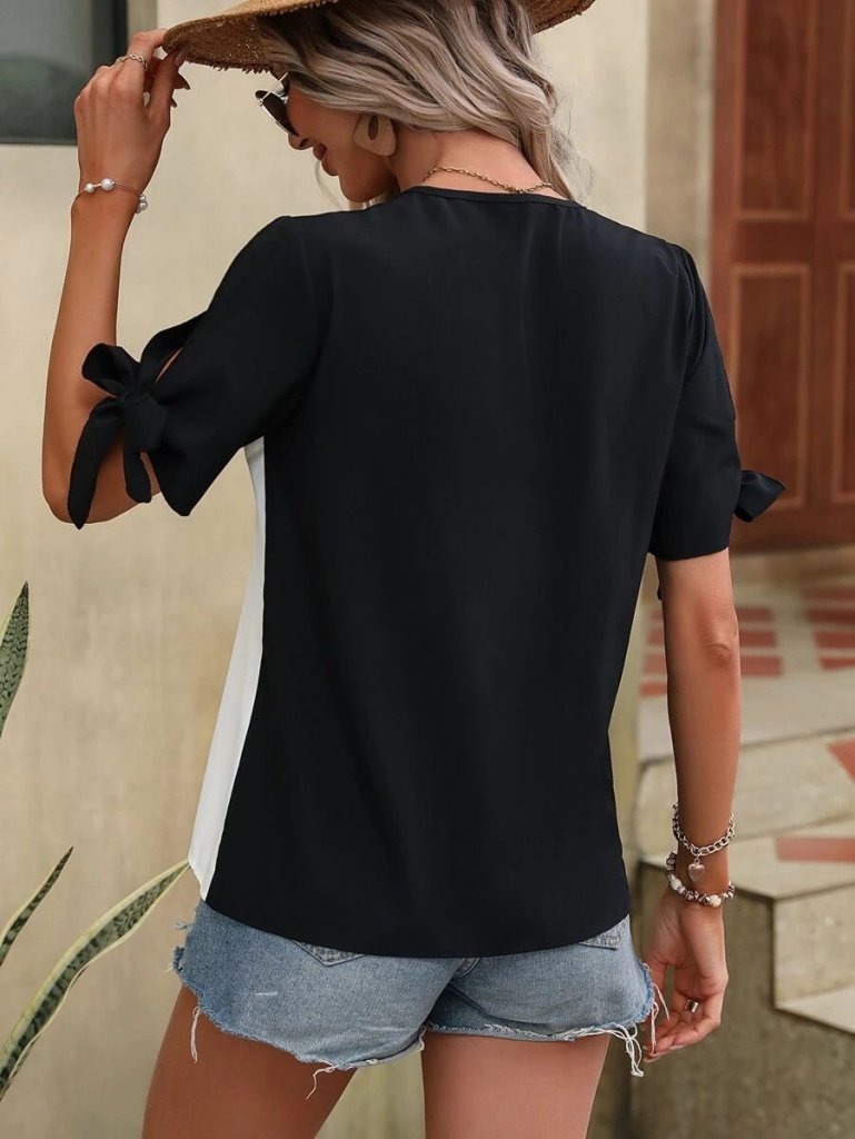 Women's Short Sleeve Tie-Front Asymmetrical Hem Two-Tone Detail Buttoned Imported Crepe Blouse